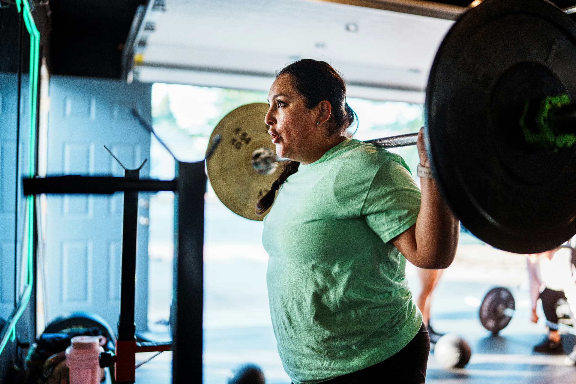 Woman training a barbell back squat