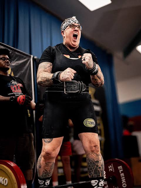 Powerlifter celebrating a successful lift on the competition platform